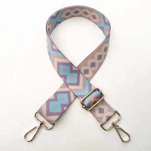 Detail of colorful ethnic geometric woven purse strap with gold metal lobster clasps