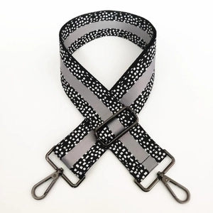 Close-up of 5cm wide spotted woven strap with adjustable gunmetal swivel snap hooks