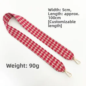 Detail of red houndstooth shoulder strap with gold lobster clasps, 5cm width and 100cm length