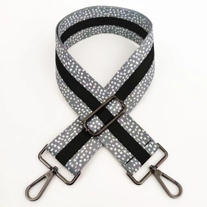 Detail of 5cm wide gray polka dot strap with gunmetal buckles and adjustable length