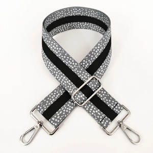 Detail of 5cm wide gray polka dot strap with silver metal hooks and adjustable buckle