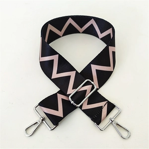 Detail of wide adjustable nylon shoulder strap with pink zigzag pattern and silver clips