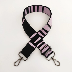 Detail of adjustable striped wide nylon bag strap with gunmetal swivel hooks and buckle