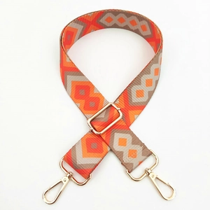 Macro detail of geometric ethnic pattern bag strap with gold metal lobster clasps