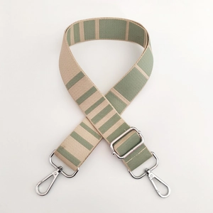 Close-up of adjustable striped woven bag strap with silver metal lobster clasps