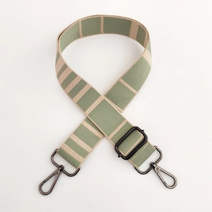 Detail of wide striped canvas shoulder strap with dark grey metal rotating hooks