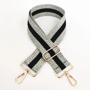 Detail of 5cm wide woven shoulder strap with speckled pattern and gold metal buckles