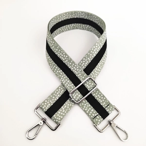 Detail of adjustable wide mint green dot woven strap with silver metal lobster hooks