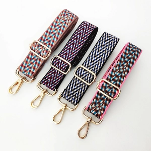 Detail of four colorful woven jacquard straps with golden metal lobster clasps and buckles