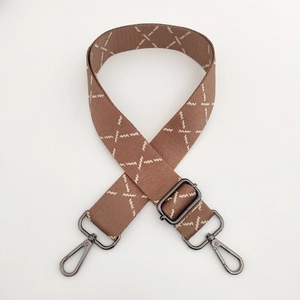 Detail of striped wide bag strap with wave embroidery and gunmetal swivel hooks