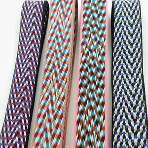Close-up of four colorful herringbone woven thick shoulder straps for crossbody bags
