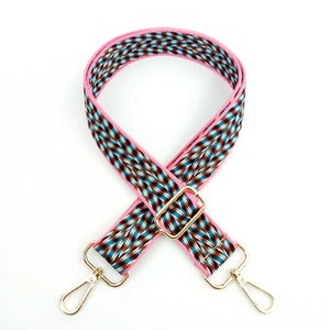 Close-up of colorful woven geometric bag strap with premium gold metal swivel hooks