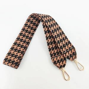 Close-up of wide houndstooth bag strap with premium gold metal lobster clasps