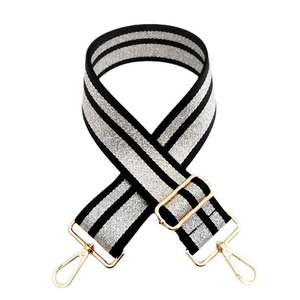 Detail of adjustable black and silver striped bag strap with gold metal swivel hooks