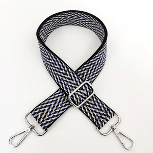 Close-up of wide bohemian jacquard bag strap with blue V-wave pattern and silver buckles