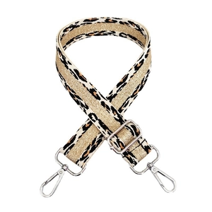 Detail of leopard print bag strap with golden metallic thread and silver lobster claws