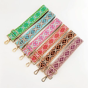 Detailed view of bohemian jacquard woven bag straps with gold metal lobster clasps