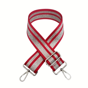 Macro detail of red woven strap with silver glitter stripes and silver metal swivel hooks