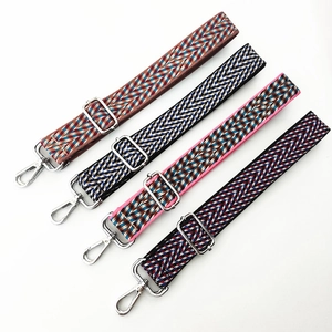Detail of four colorful woven adjustable shoulder straps with silver metal hardware buckles