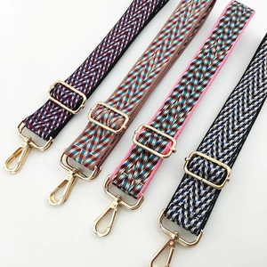 Detail of colorful woven shoulder straps with golden metal buckles and ethnic patterns