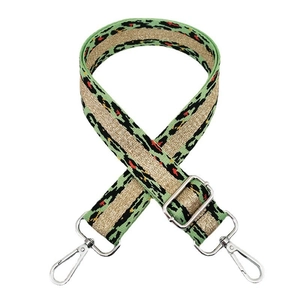 Detail of adjustable green leopard woven strap with gold metallic thread and silver hooks