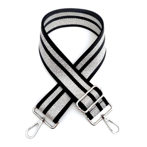 Detail of wide silver stripe bag strap with adjustable buckle and metal swivel hooks