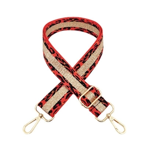Detailed view of red leopard print bag strap with gold tinsel and luxury hardware
