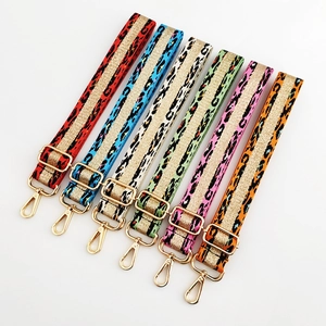 Detail of colorful leopard print shoulder straps with gold glitter tape and metal clasps