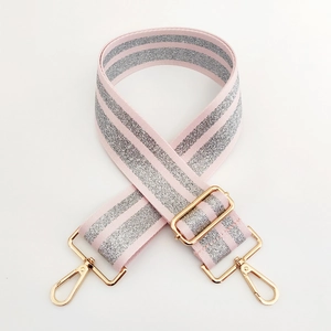 Detail of adjustable pink and silver glitter shoulder strap with gold metal hooks