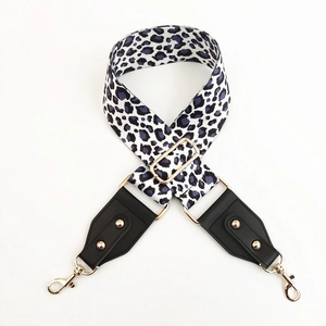 Close-up of adjustable leopard print wide strap with gold-tone hardware and leather ends