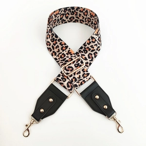 Close-up of leopard print bag strap with gold metal hardware and black leather detail