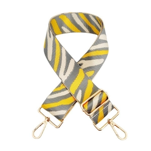 Close-up of zebra pattern wide adjustable bag strap with golden metal lobster clasps