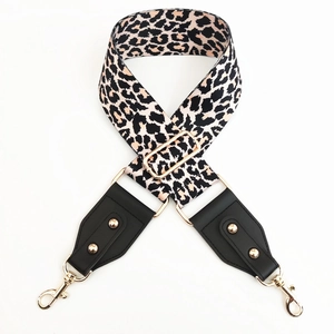 Adjustable leopard print canvas bag strap with black leather ends and gold hardware