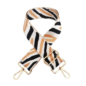 Close-up of zebra pattern wide strap with golden lobster clasps and adjustable buckle