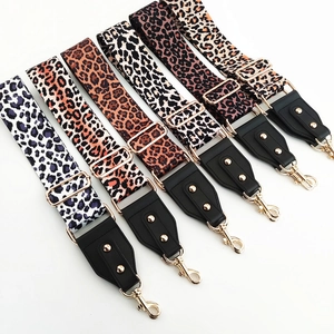 Detail of adjustable leopard print wide shoulder straps with gold metal hooks for handbags