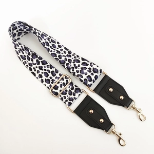Close-up of leopard print wide strap with gold metal lobster clasps and leather ends