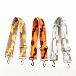 Close-up of wide adjustable jacquard shoulder straps with rose gold metal hardware