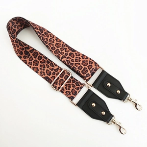 Adjustable leopard print bag strap with golden hardware and black leather ends