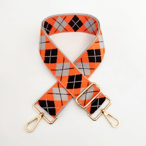 Detail of adjustable wide shoulder strap with orange and grey argyle woven pattern