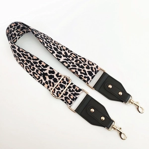 Detail of adjustable leopard print wide strap with gold hardware and leather ends