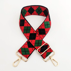 Close-up of British style red and green argyle pattern wide strap with gold metal hooks