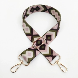 Close-up of geometric diamond pattern strap with polished gold-tone metal buckles