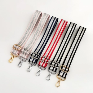 Detail of adjustable 3.8cm fabric bag straps with silver glitter stripes and metal clips