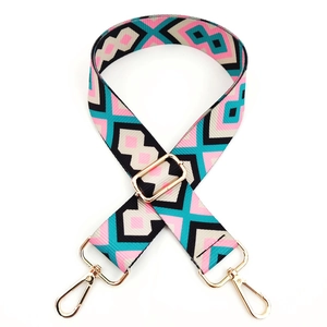 Close-up of diamond pattern woven bag strap with polished gold-tone metal buckles