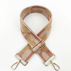 Detail of adjustable geometric jacquard strap with gold-tone hardware and wave pattern