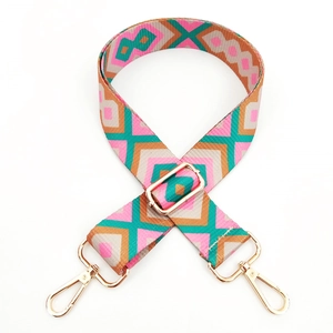 Detail of bohemian geometric woven purse strap with light gold metal lobster clasps