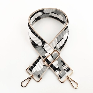 Detail of adjustable 5cm woven shoulder strap with grey camouflage pattern and gold buckles