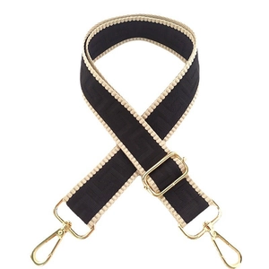 Macro shot of wide nylon braided bag strap with black geometric patterns and gold hooks