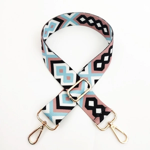 Close-up of diamond pattern jacquard strap with gold lobster clasps and metal buckle