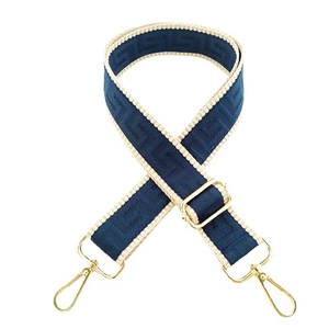 Detail of adjustable geometric jacquard shoulder strap with gold metal buckles for handbags